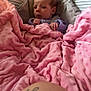 Rylee is registered to the contest to win money with this photo: baby, infant, blanket, pink, baby_seat, face, expression, tattoo, skin, cushion, indoor, person, newborn, comfort, soft, cozy, clothing, wrapped, portrait, resting