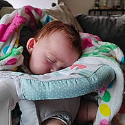 Jonathan joined the competition — help win amazing prizes! baby, infant, sleeping, nap, face, portrait, blanket, colorful_blanket, baby_seat, cushion, home, indoors, cozy, brown_hair, closed_eyes, resting, nursery, furniture, soft_texture, child