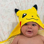 Raidel joined the competition — help win amazing prizes! baby, child, pikachu, yellow, hooded_towel, face, skin, smile, eyes, blanket, floral_pattern, indoors, cute, infant, portrait, person, childhood, soft_texture, happy, lying_down