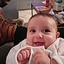 Lilith a rejoint le concours — aidez-le/la à gagner de superbes lots ! baby, infant, smiling, closeup, indoor, blanket, onesie, hand, big_eyes, chubby_cheeks, sofa, boot, shoe, coffee_table, baby_bottle, pacifier, tile_floor, living_room, happy, portrait