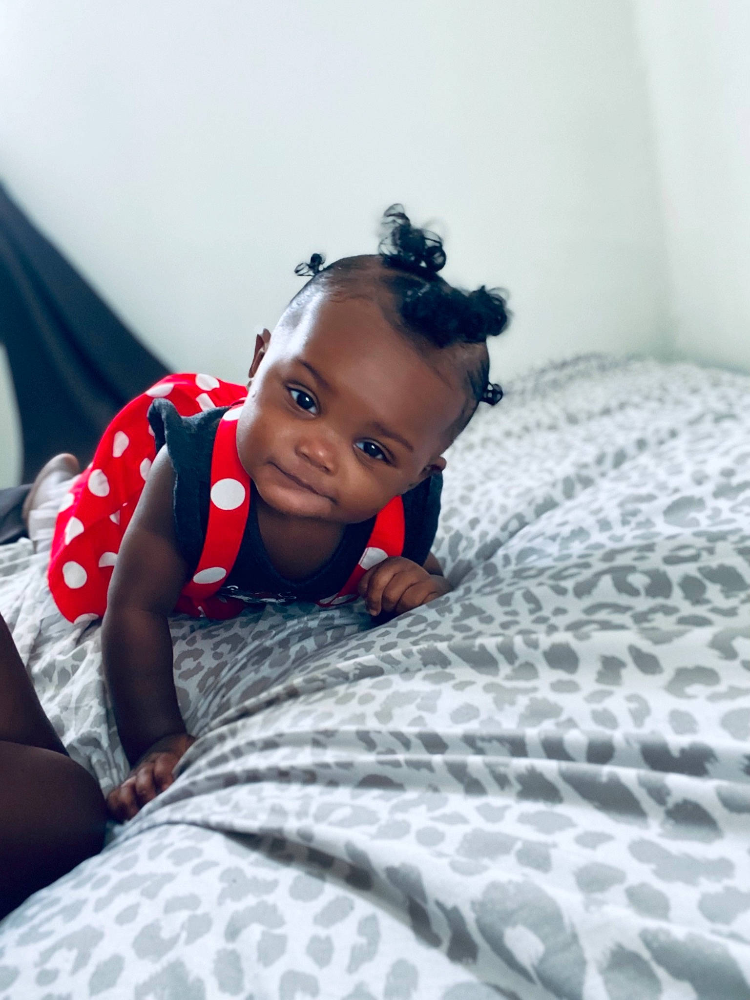 Rihanna is registered to the contest to win money with this photo: baby, baby_toddler_clothing, bed, bedding, black_hair, child, comfort, cool, eye, face, flash_photography, flooring, fun, happy, head, linens, person, room, sitting, skin