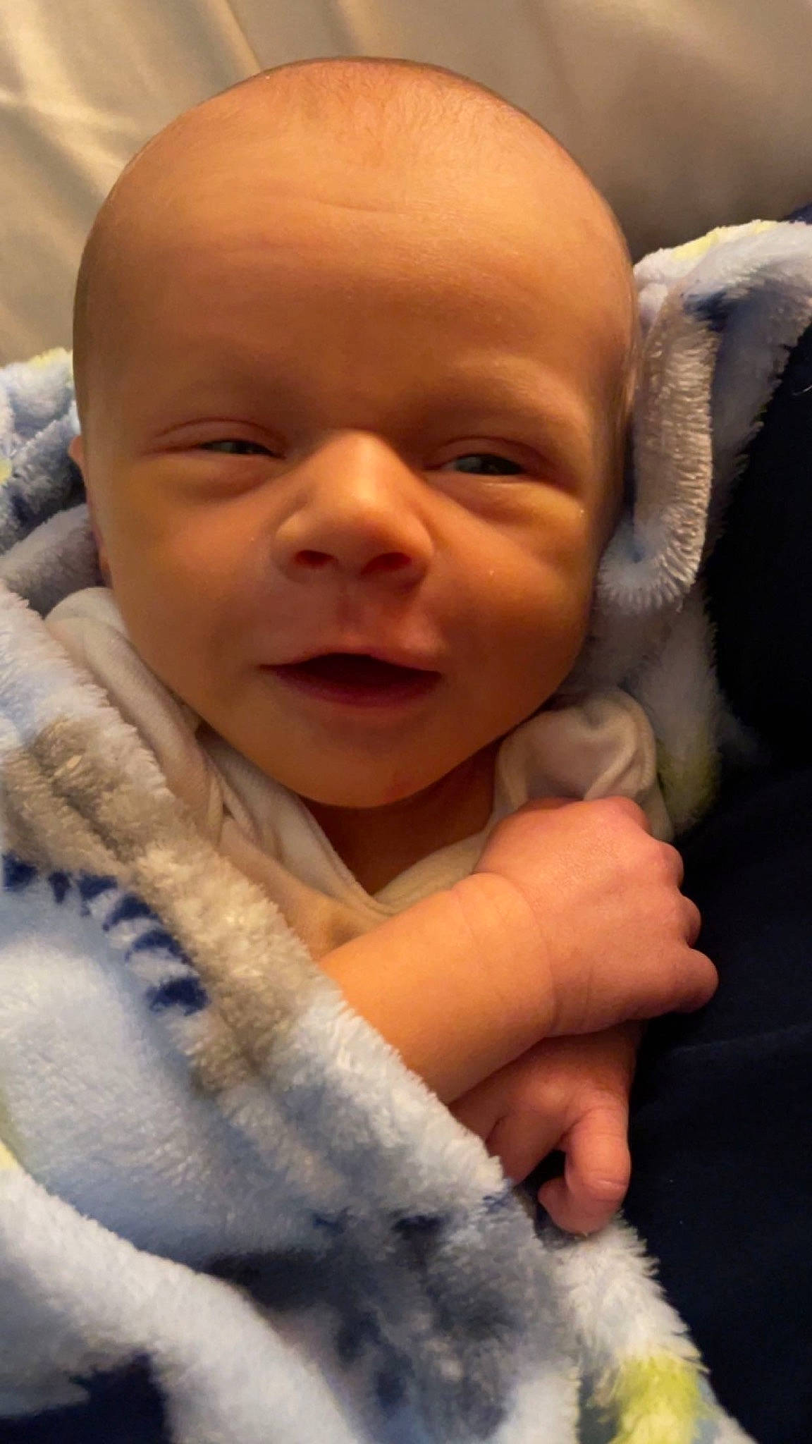 Bennett is registered to the contest to win money with this photo: baby, baby_toddler_clothing, cheek, child, chin, comfort, ear, eyebrow, finger, gesture, happy, iris, linens, lip, mouth, nose, person, skin, smile, thumb