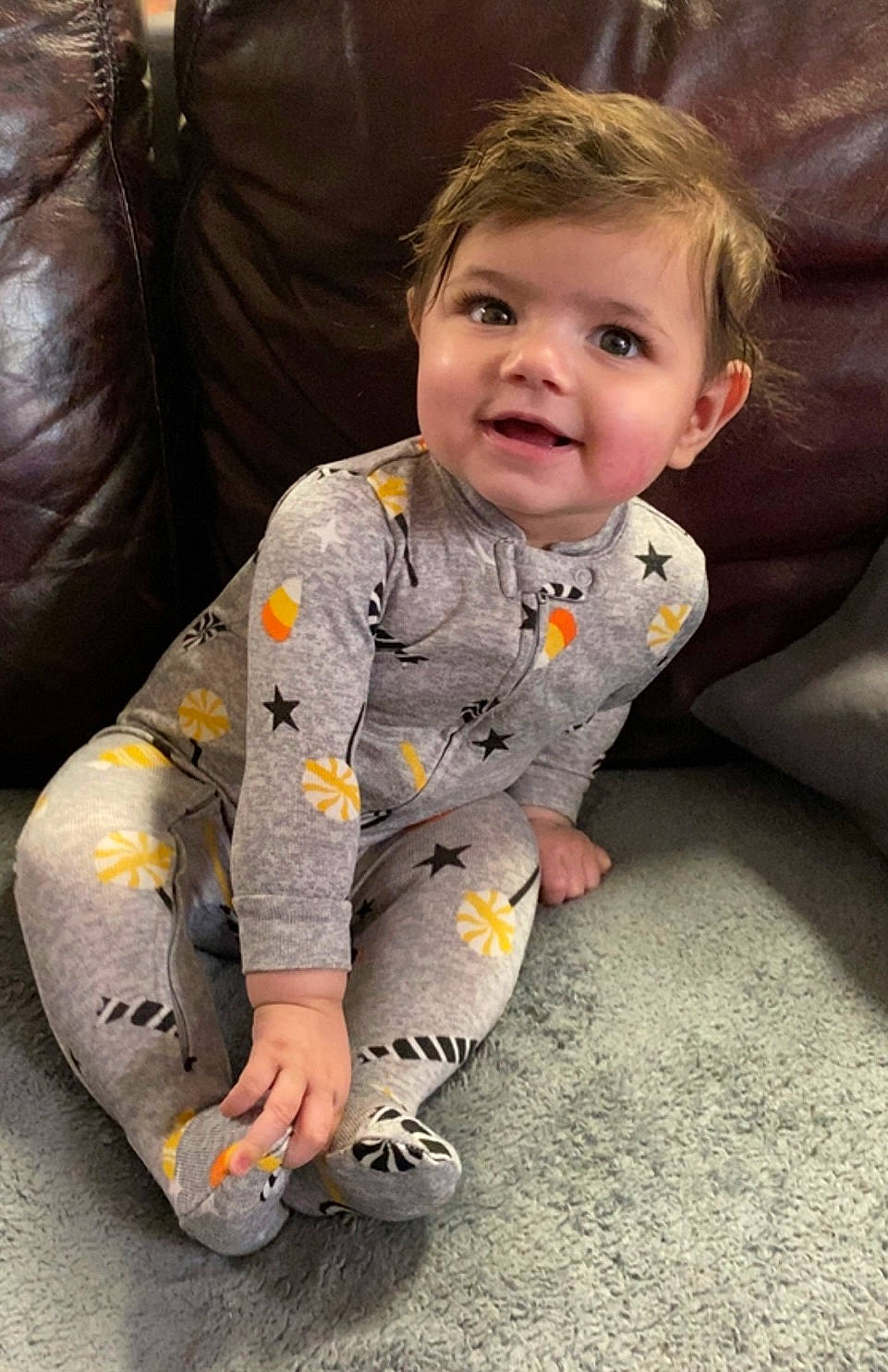 Erika is registered to the contest to win money with this photo: baby, baby_toddler_clothing, bean_bag, carmine, cheek, child, comfort, eye, face, flooring, fun, grass, happy, head, joy, leg, nose, person, sitting, sleeve