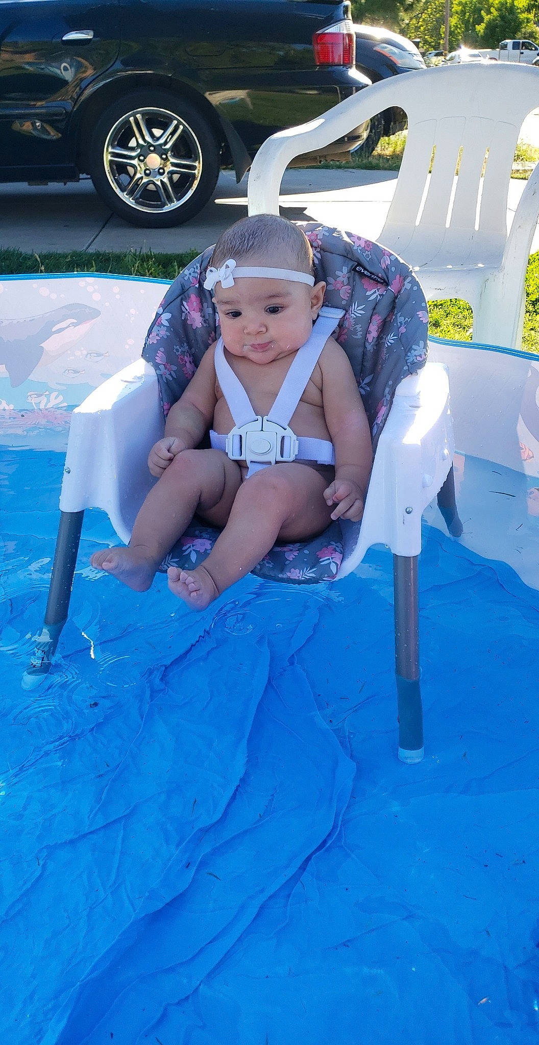 Elicia is registered to the contest to win money with this photo: blue, car, child, fun, games, headwear, leg, leisure, person, recreation, summer, swimming_pool, vacation, water