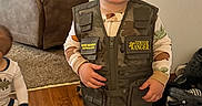 Axell joined the competition — help win amazing prizes! toddler, child, smiling, indoor, clothing, hat, cap, pajamas, vest, junior_ranger, person, carpet, floor, shoes, baby, furniture, home, cute, happy, portrait