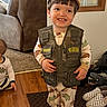 toddler, child, smiling, indoor, clothing, hat, cap, pajamas, vest, junior_ranger, person, carpet, floor, shoes, baby, furniture, home, cute, happy, portrait