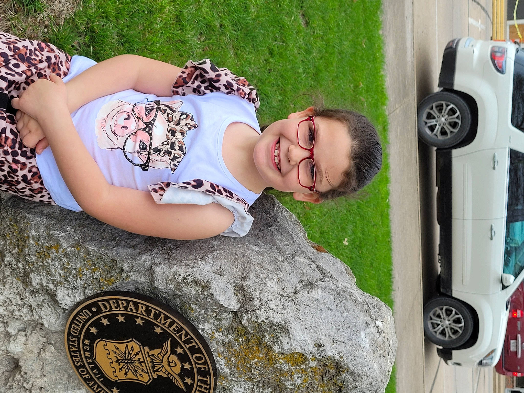 Arya joined the competition — help win amazing prizes! automotive_design, automotive_tire, car, eyewear, fashion, glasses, grass, green, happy, human_leg, joy, motor_vehicle, pattern, people, person, plant, thigh, tire, toddler, tree