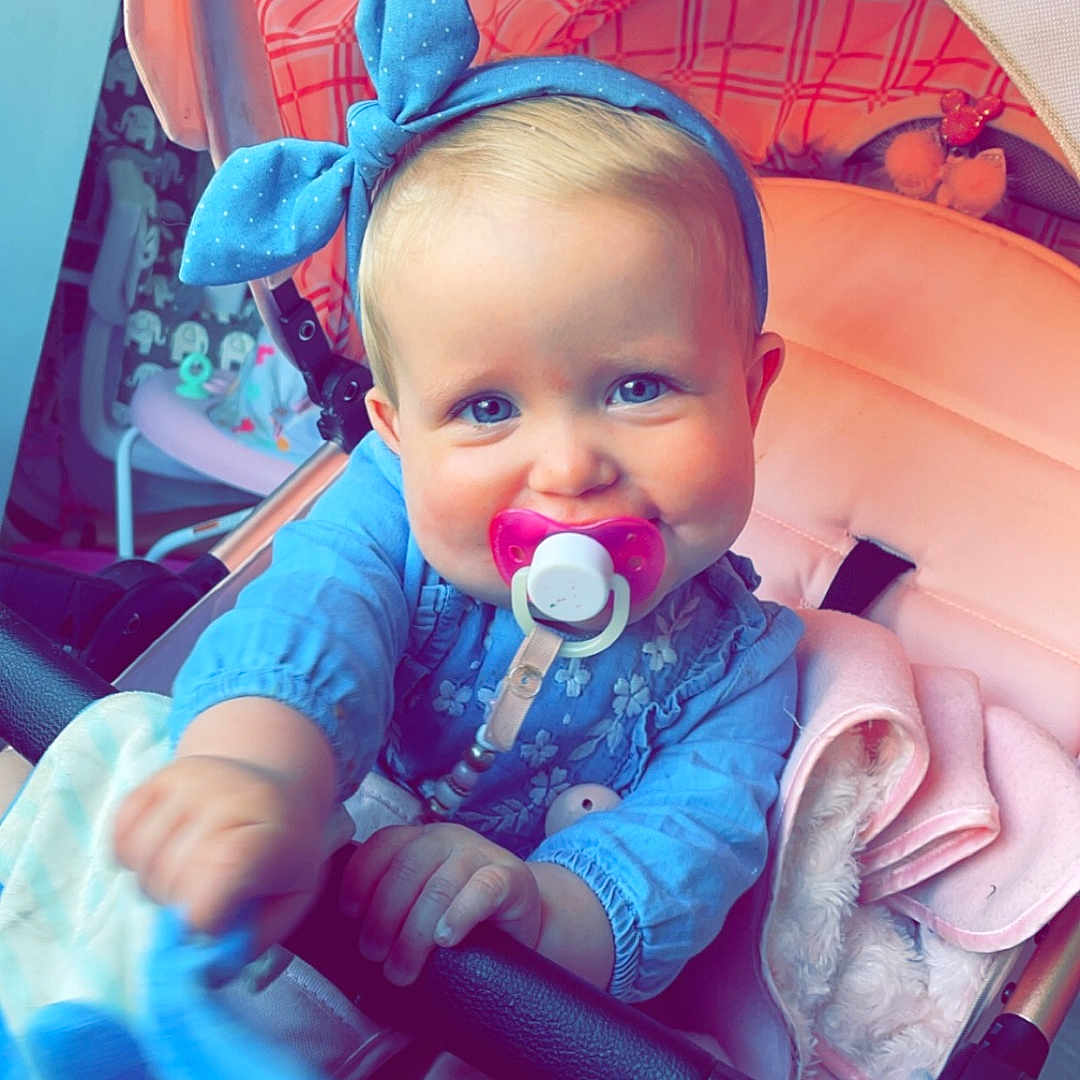Millie-Mae joined the competition — help win amazing prizes! baby, bed, bodypart, clothing, coat, cutlery, face, finger, furniture, hand, happy, hat, head, jacket, person, photography, portrait, smile, spoon, stroller