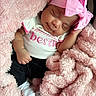 baby, sleeping, pink_headband, blanket, infant, cozy, cute, newborn, soft_texture, child, clothing, pink, white_shirt, black_pants, socks, portrait, resting, toddler, peaceful, indoor
