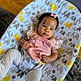 baby, infant, child, pink_bow, pink_clothing, white_tights, elephant_pattern, cushion, baby_seat, floor, wooden_floor, carpet, indoor, portrait, cute, looking_at_camera, small_hands, curious_expression, infant_fashion, comfort
