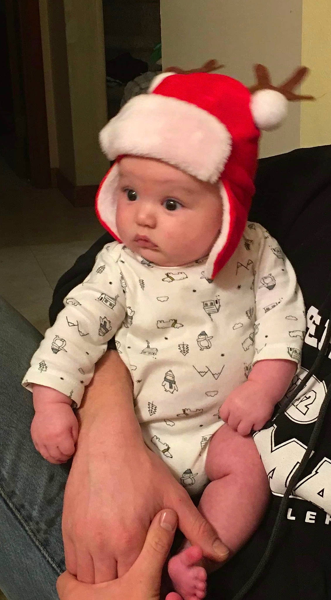 Levi is registered to the contest to win money with this photo: baby, baby_toddler_clothing, cap, child, christmas, christmas_eve, fictional_character, hat, headgear, headwear, person, sitting, sleeve, toddler