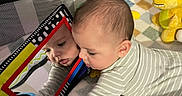 Jasper joined the competition — help win amazing prizes! baby, reflection, mirror, pajamas, toy, plush_toy, nursery, blanket, child, infant, striped_clothing, playtime, soft_toy, colorful, face, curious, indoor, crawling, smiling, closeup