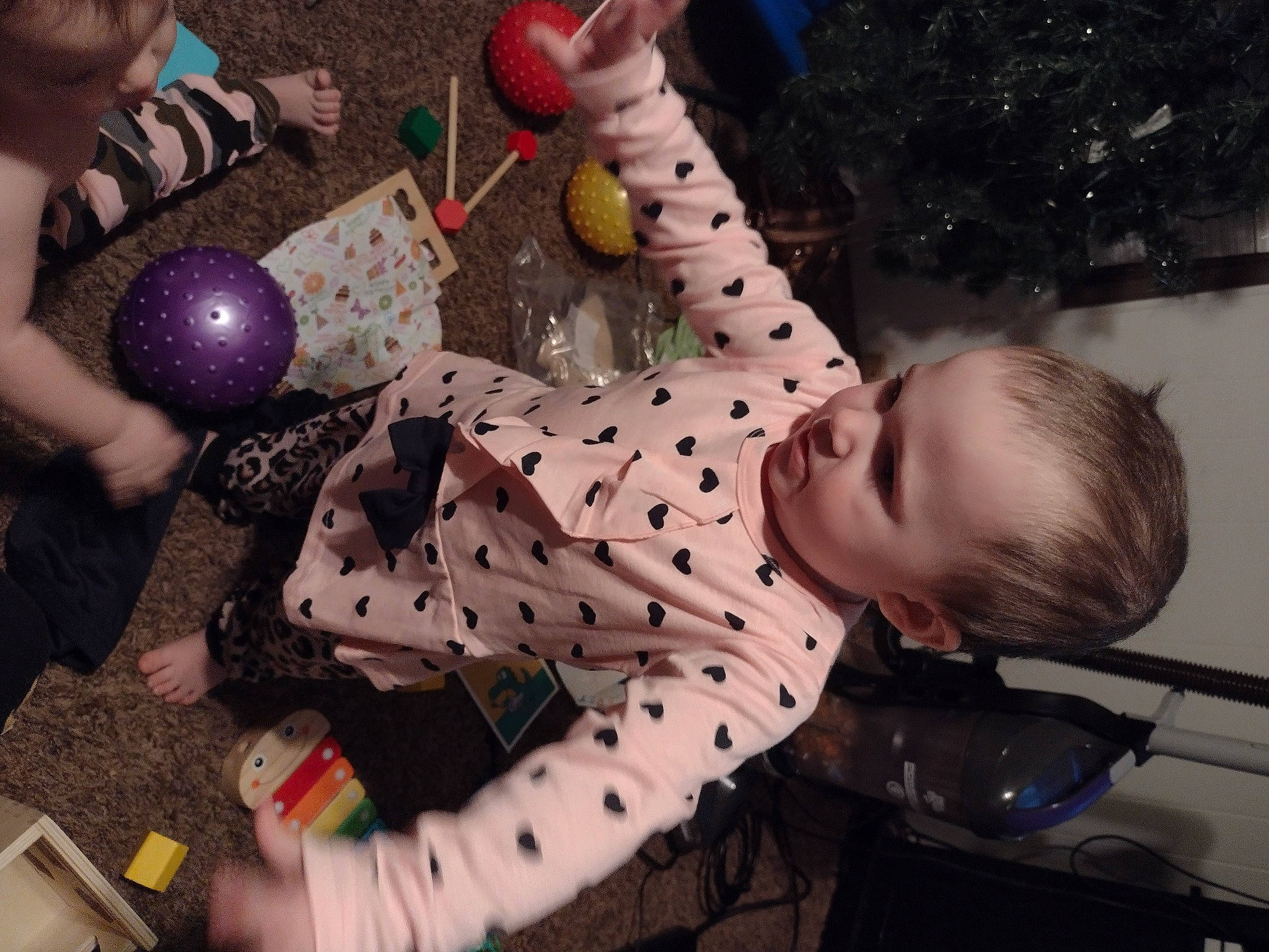 Willow is registered to the contest to win money with this photo: baby, carmine, child, event, flooring, fun, happy, leisure, party_supply, pattern, person, play, polka_dot, sitting, toddler, toy