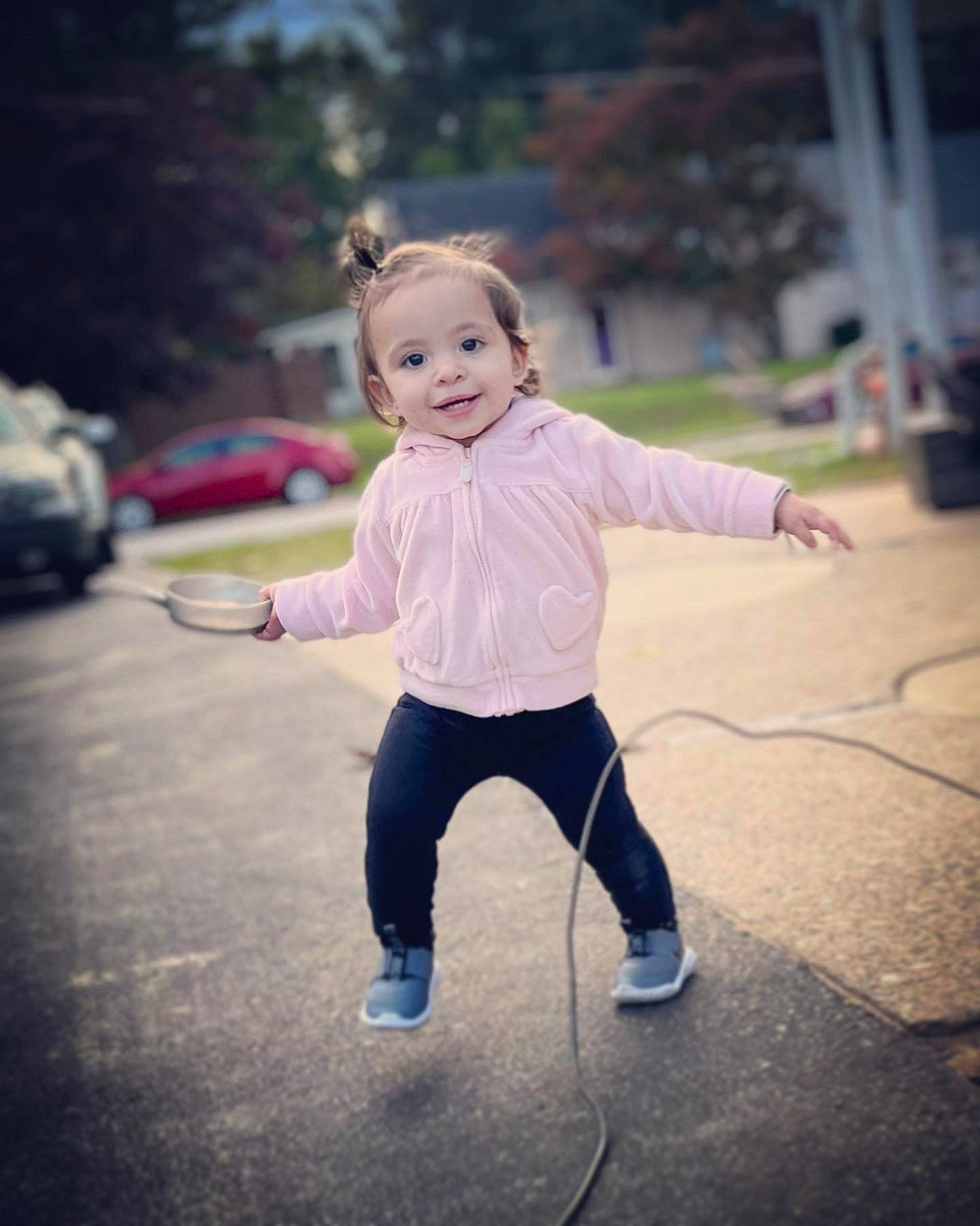 Ava is registered to the contest to win money with this photo: asphalt, baby, child, eye, flash_photography, flooring, fun, gesture, grass, hair, happy, joy, people_in_nature, person, plant, recreation, road, road_surface, smile, toddler