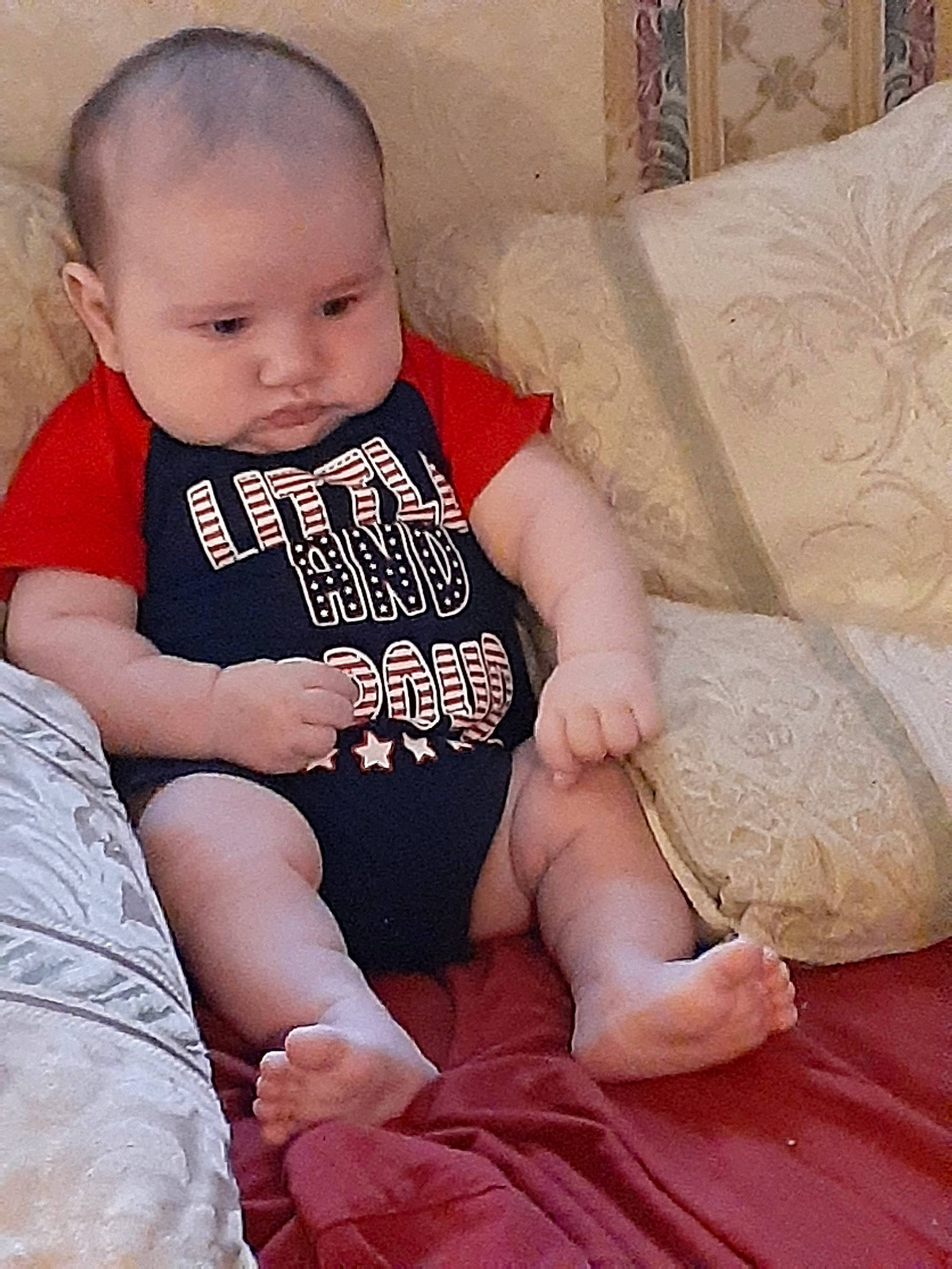 Bobby joined the competition — help win amazing prizes! baby, baby_products, baby_toddler_clothing, child, comfort, couch, finger, foot, hand, home_accessories, human, linens, living_room, nail, person, sitting, skin, sock, throw_pillow, thumb