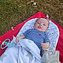 Dastan participe au concours pour gagner de l'argent avec cette photo : baby, infant, blanket, striped_shirt, heart, toy, rattle, plush_toy, grass, outdoor, cushion, red_blanket, white_blanket, face, person, cute, lying_down, child, tongue_out, playful