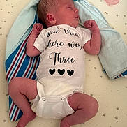 Brighton is registered to the contest to win money with this photo: newborn, baby, sleeping, onesie, pacifier, towel, star_pattern, infant, bed, blanket, cute, peaceful, clothing, skin, lying_down, rest, soft, nursery, child, portrait