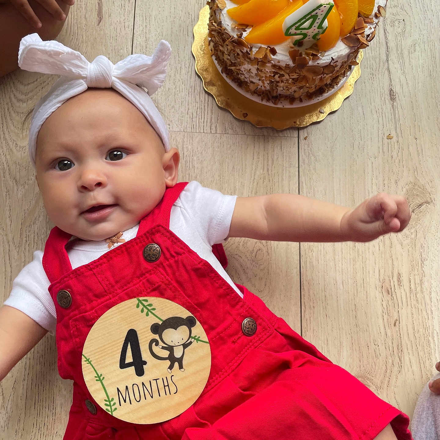 Terrie joined the competition — help win amazing prizes! baby, birthday, cake, candle, celebration, child, cute, dessert, food, fruit_topping, hands, happy, headband, infant, legs, lying_down, milestone_sticker, red_overalls, smiling, wooden_floor