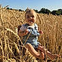 toddler, child, wheat_field, outdoor, sunlight, denim_overalls, barefoot, smile, chair, nature, blue_sky, grass, happy, summer, field, portrait, plant, young_child, daylight, countryside