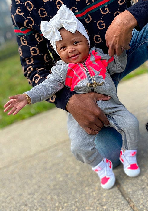 Sariyah joined the competition — help win amazing prizes! baby, baby_toddler_clothing, cap, child, face, fun, gesture, grass, happy, head, headwear, jeans, joy, leisure, person, pink, plant, recreation, shoe, smile