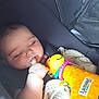 baby, infant, sleeping, car_seat, toy, lamaze, blanket, hand, thumb, face, child, cute, soft_toy, colorful, comfort, indoors, peaceful, rest, young, person