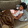Aria joined the competition — help win amazing prizes! child, baby, sleeping, couch, blanket, pillow, indoor, cozy, family, rest, nap, clothing, headwear, person, comfort, relaxation, home, toddler, sibling, quiet