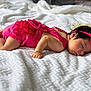 Aria is registered to the contest to win money with this photo: baby, sleeping, infant, pink_clothing, headband, lace, blanket, soft_texture, rest, cute, peaceful, portrait, child, lying_down, indoors, newborn, person, skin, face, hand