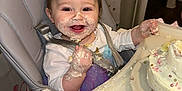 Karlee is registered to the contest to win money with this photo: baby, high_chair, cake, messy, smiling, face_paint, birthday, celebration, food, happy, child, indoor, plate, clothing, hand, table, person, fun, party, sweet