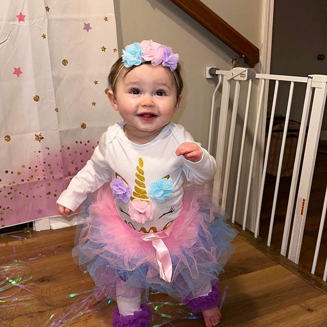 Karlee joined the competition — help win amazing prizes! baby, baby_gate, blue, child, curtain, cute, decor, flower, happy, headband, indoor, pink, purple, smile, star_pattern, toddler, tutu, unicorn, white_clothing, wooden_floor
