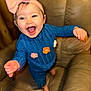 Karlee is registered to the contest to win money with this photo: baby, child, smiling, happy, headband, pink_bow, blue_outfit, flowers, couch, leather, indoor, person, cute, joy, toddler, hands, feet, portrait, warm_lighting, cozy