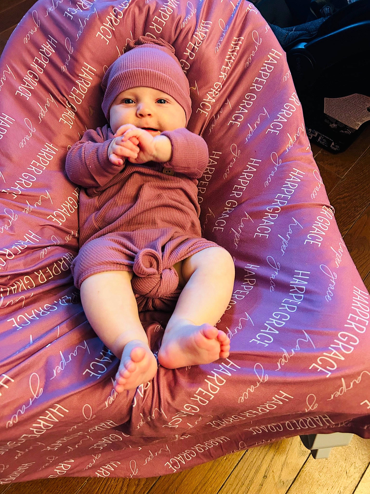 Harper is registered to the contest to win money with this photo: baby, baby_toddler_clothing, child, comfort, event, flooring, fun, happy, headwear, human_leg, lap, magenta, pattern, person, pink, purple, sitting, skin, textile, thigh