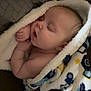 baby, sleeping, blanket, cozy, child, infant, peaceful, cute, soft, wrapped, hands, face, mouth_open, pattern, texture, warm, resting, indoors, comfort, toddler