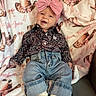 Tatum joined the competition — help win amazing prizes! baby, child, smile, headband, bow, jeans, shirt, blanket, cowboy_hat, pattern, fabric, sitting, feet, sock, cute, happy, portrait, indoor, cozy, relaxed