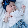 baby, sleeping, blue_bow, white_lace_top, jeans, infant, soft_blanket, cute, peaceful, child, portrait, fashion, headband, closeup, relaxing, casual_clothing, adorable, resting, indoor, newborn