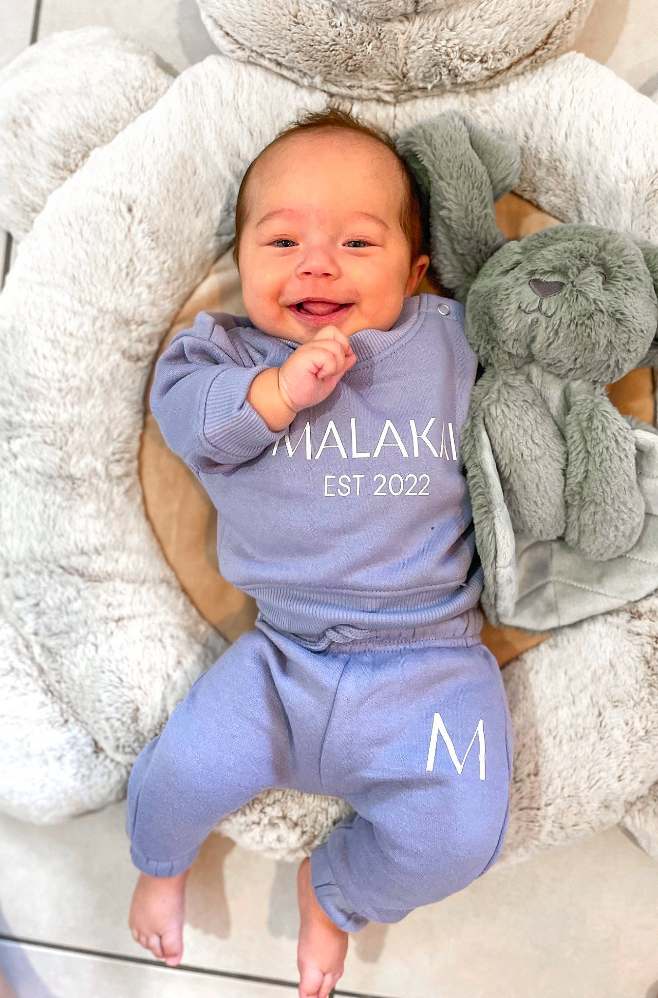 Malakai joined the competition — help win amazing prizes! baby, baby_toddler_clothing, cheek, child, comfort, face, facial_expression, fur, happy, headgear, linens, organ, person, room, sitting, skin, sleeve, smile, textile, toddler