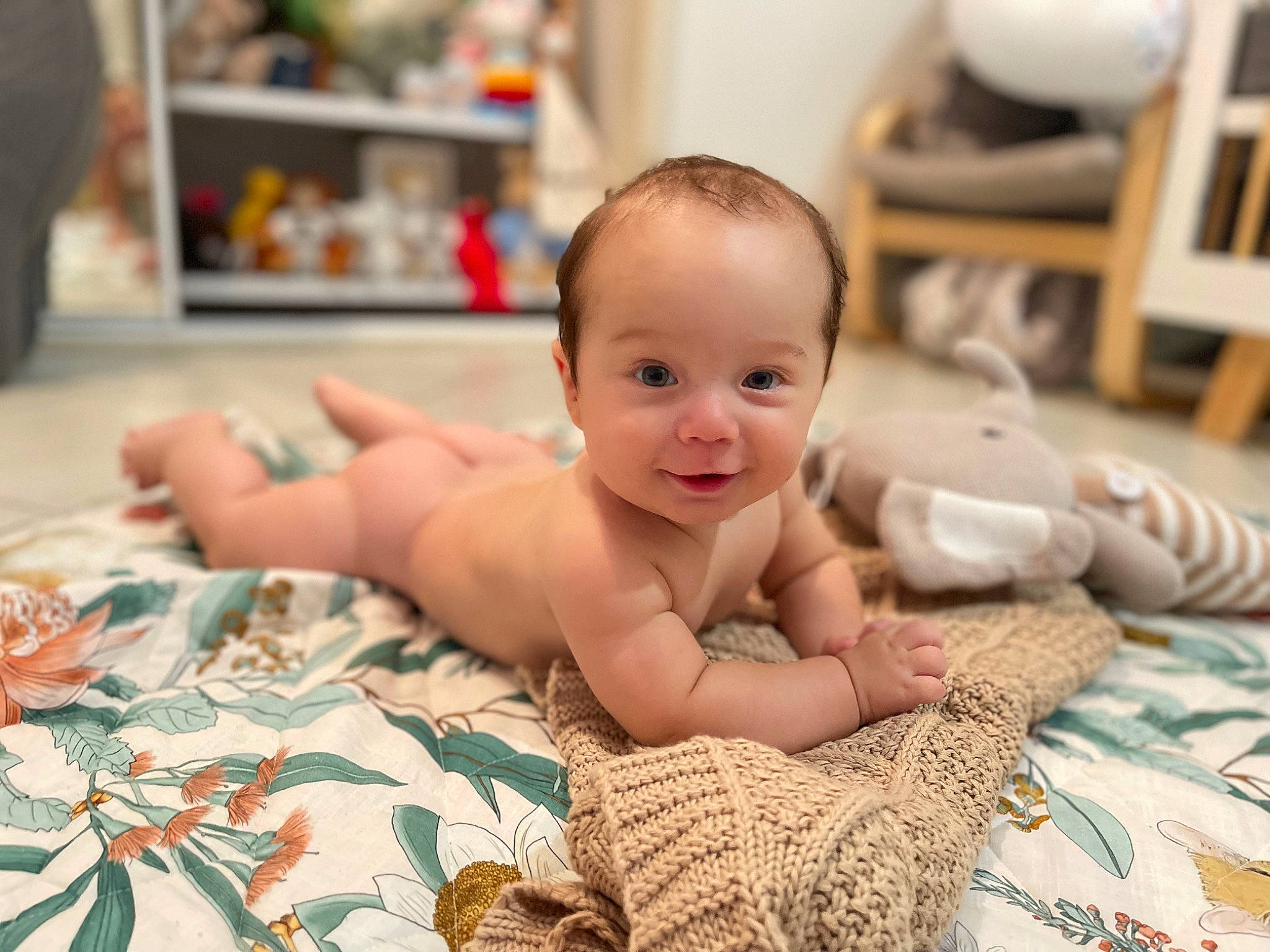 Malakai is registered to the contest to win money with this photo: baby, baby_toddler_clothing, cheek, child, comfort, eye, finger, flooring, foot, fun, happy, iris, linens, pattern, person, room, sitting, skin, smile, toddler