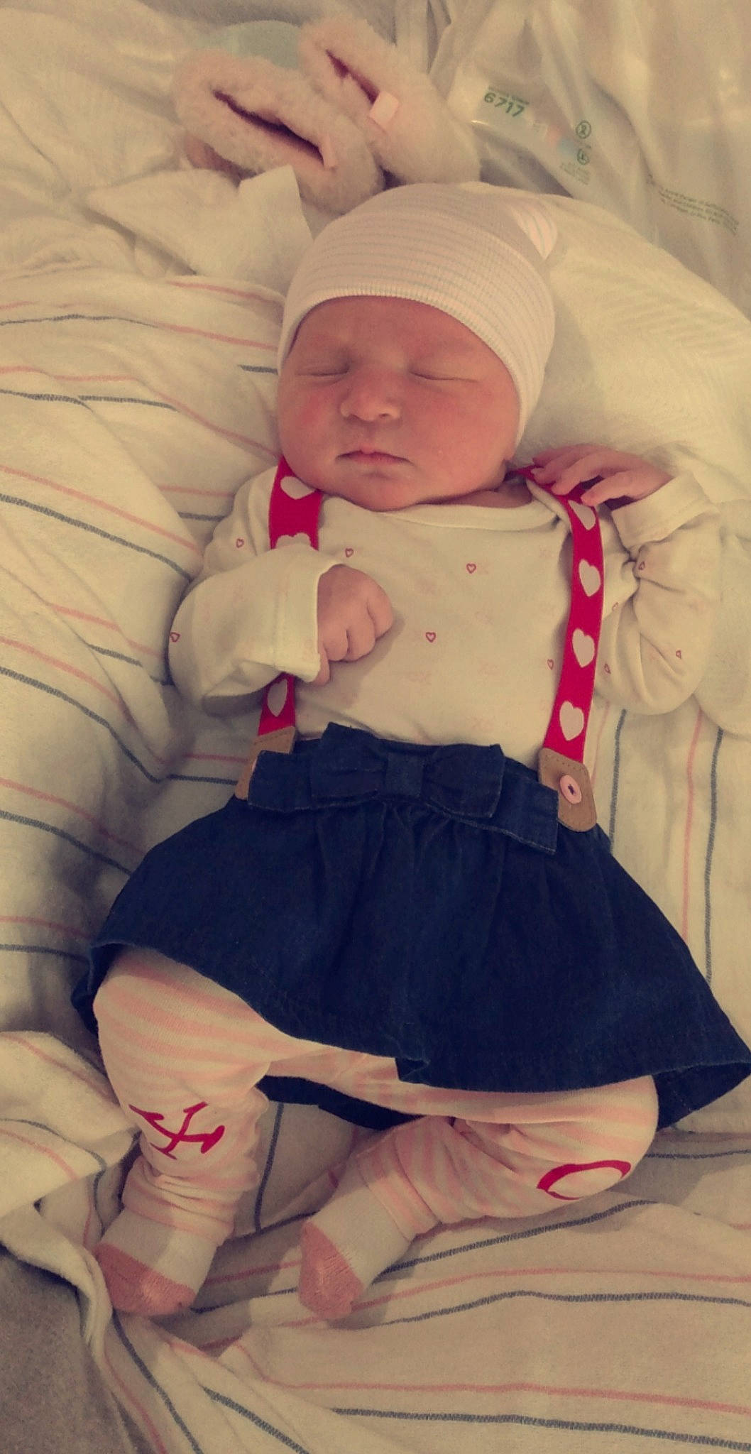 Natalie is registered to the contest to win money with this photo: baby, baby_sleeping, baby_toddler_clothing, cheek, comfort, finger, hand, head, headwear, human_body, iris, knee, pattern, person, pink, skin, sleeve, sock, thigh, thumb