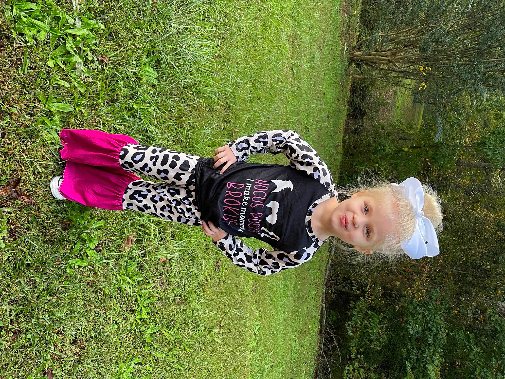 Raelyn is registered to the contest to win money with this photo: baby, baby_toddler_clothing, child, fun, grass, grassland, happy, hat, headgear, lawn, leisure, pattern, people_in_nature, person, plant, shrub, sleeve, smile, toddler, tree