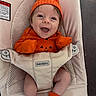 baby, child, infant, smiling, happy, portrait, orange, pumpkin, hat, costume, clothing, carrier, babybjorn, safety_straps, seated, indoor, cushion, chair, feet, photography