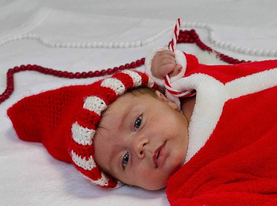 Kasey May is registered to the contest to win money with this photo: baby, baby_toddler_clothing, carmine, child, comfort, costume_hat, eye, fashion_accessory, fur, happy, headwear, linens, pattern, person, portrait_photography, room, sleeve, textile, toddler, winter