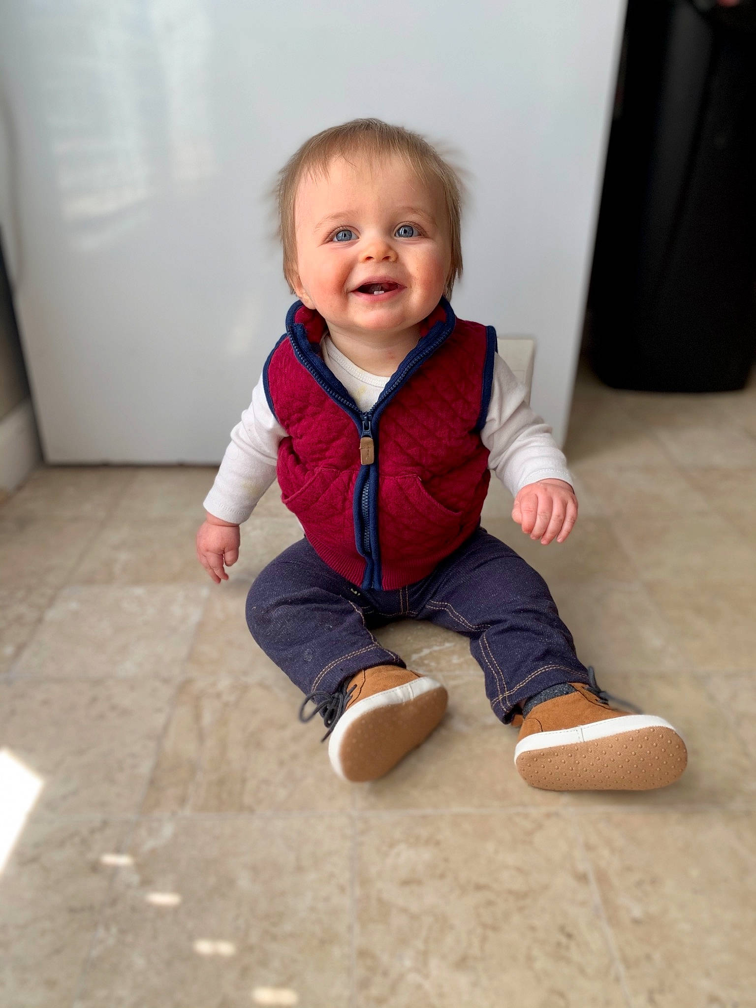 Kaiden is registered to the contest to win money with this photo: baby, baby_toddler_clothing, cheek, child, comfort, eye, face, floor, flooring, hardwood, head, human_body, joy, leg, person, skin, sleeve, smile, standing, t_shirt