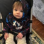 Sierra is registered to the contest to win money with this photo: toddler, child, stroller, hoodie, blue_eyes, indoor, carpet, couch, casual_clothing, seated, portrait, baby, cute, hands, face, expression, young_child, furniture, hood, pants