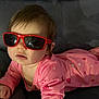 baby, child, pink_pajamas, sunglasses, red_sunglasses, couch, indoor, cute, face, person, infant, relaxing, fashion, childwear, portrait, cozy, home, young_child, funny, casual
