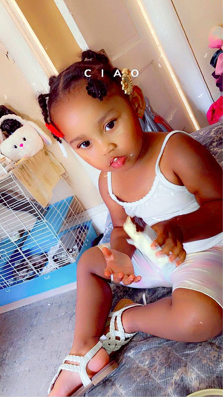 Avayah is registered to the contest to win money with this photo: abdomen, baby_toddler_clothing, black_hair, chest, child, eyelash, fashion_design, fun, happy, human_leg, jewellery, knee, leg, person, pink, sandal, sitting, skin, thigh, toddler