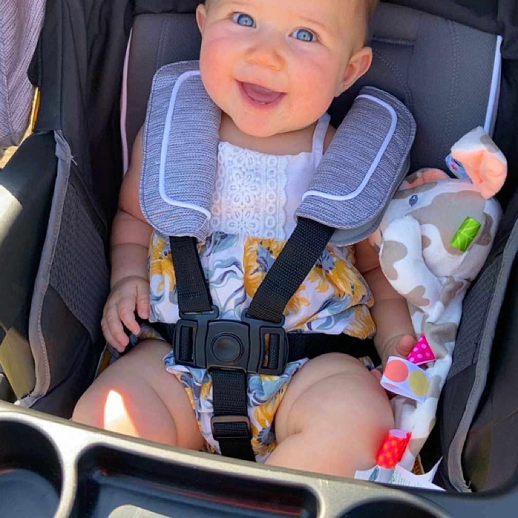 Calli is registered to the contest to win money with this photo: accessories, baby, car, city, clothing, coat, face, happy, head, homedecor, jacket, person, photography, portrait, smile, strap, stroller, sunglasses, transportation, vehicle