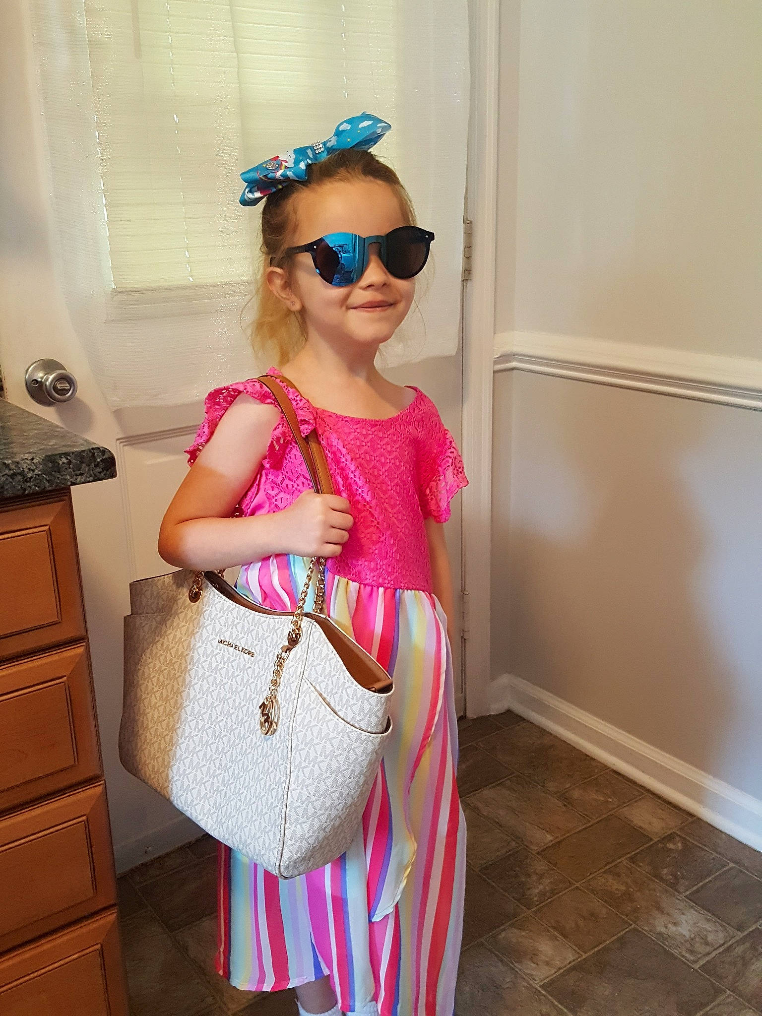 Cailyn is registered to the contest to win money with this photo: bag, child, clothing, dress, ear, eyewear, fashion, fashion_accessory, glasses, handbag, joint, magenta, neck, person, pink, shoulder, sleeve, sunglasses, toddler, waist