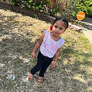 Loreanny Kataleya joined the competition — help win amazing prizes! brick_wall, bushes, casual_clothing, child, daylight, girl, grass, hair_bow, lawn, outdoor, pants, person, portrait, security_sign, shirt, shoes, sidewalk, smiling, standing, sunlight