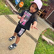 Loreanny Kataleya joined the competition — help win amazing prizes! child, kid, barbie, pink_cap, black_outfit, shorts, tshirt, sneakers, nike, sidewalk, grass, brick_house, outdoor, curious, person, walking, street_sign, greenery, fashion, casual