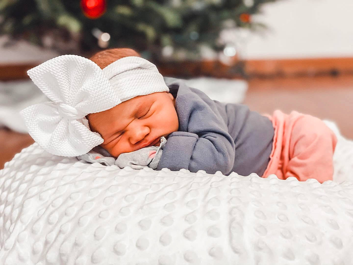 Gentry is registered to the contest to win money with this photo: baby, baby_sleeping, baby_toddler_clothing, beanie, blanket, bonnet, cheek, christmas, christmas_decoration, comfort, headwear, holiday, hood, knit_cap, linens, nap, person, skin, sleep, textile
