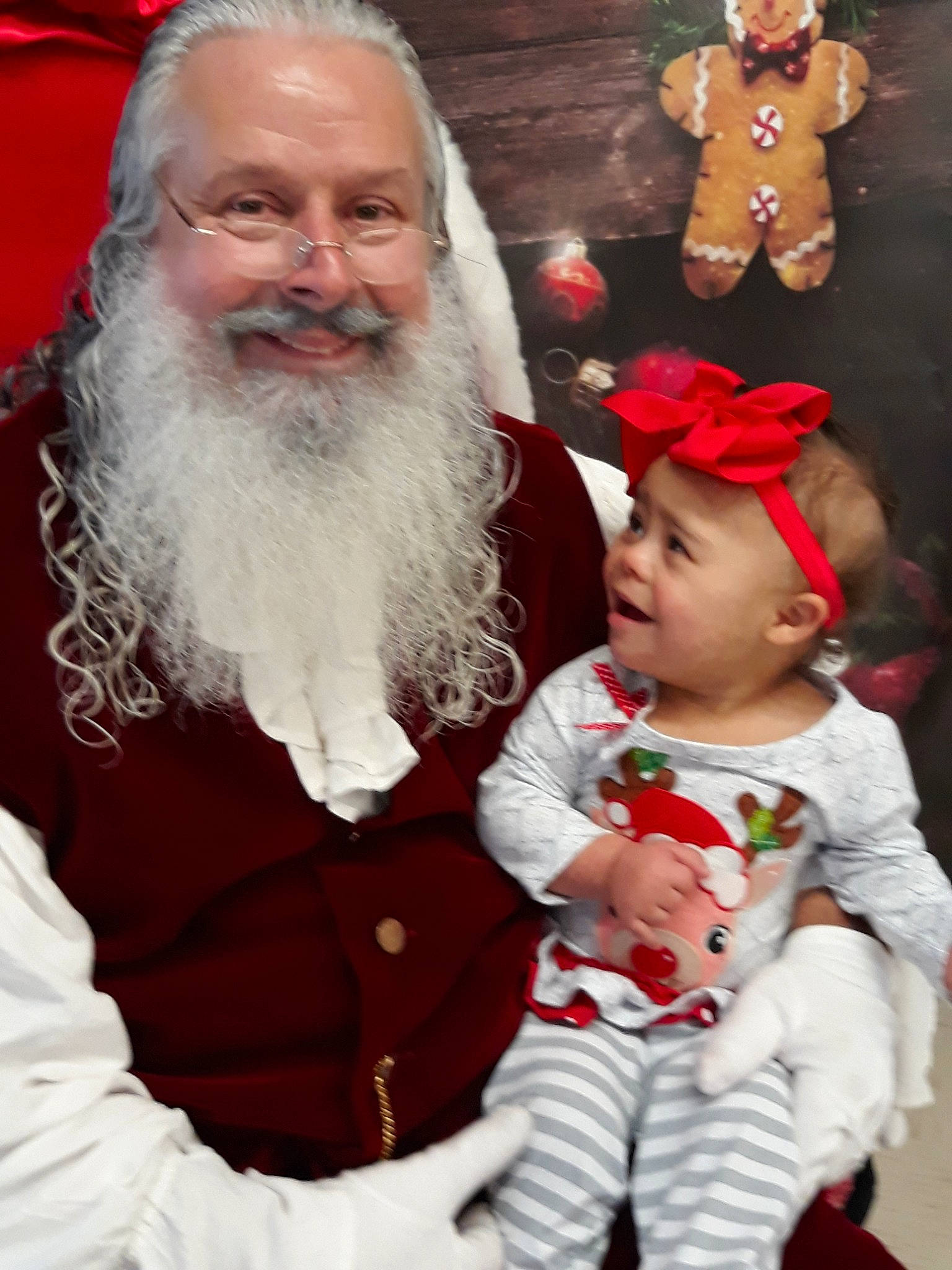 Talyn is registered to the contest to win money with this photo: beard, child, christmas, christmas_eve, event, facial_hair, fictional_character, grandparent, holiday, joy, lap, person, santa_claus